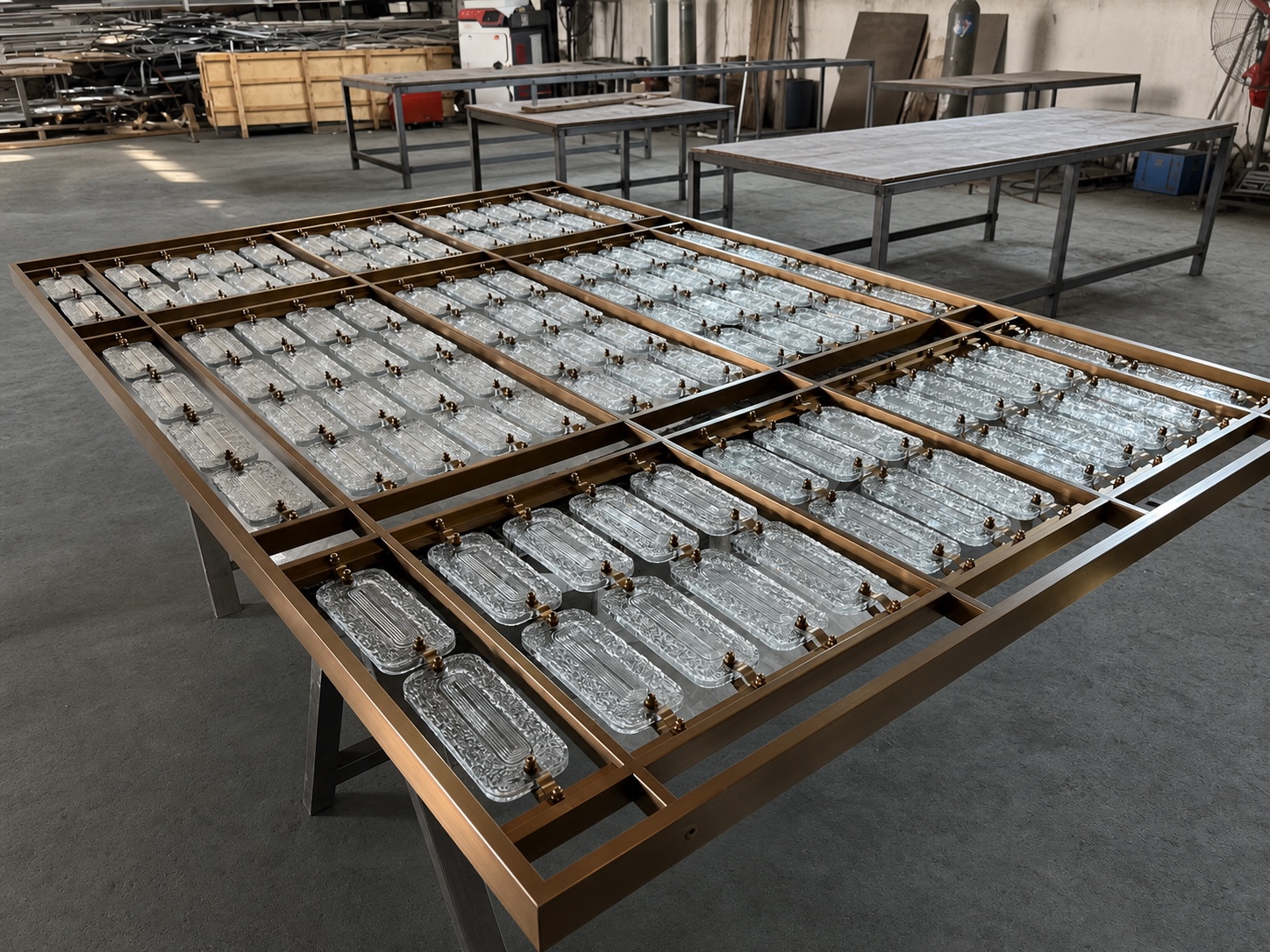 Completed workshop layout of clear rectangular crystal pieces inside a divided metal frame