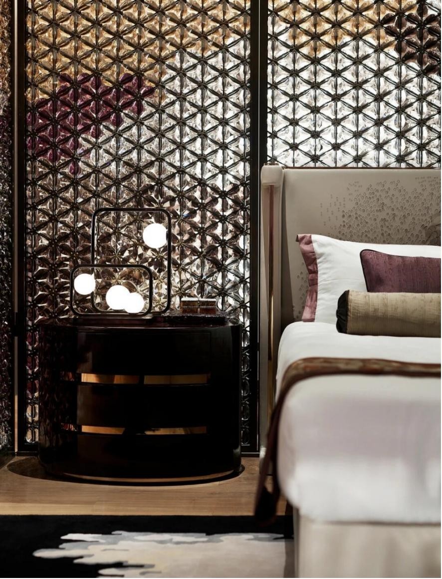 Luxury hotel bedroom with a crystal screen beside the bed