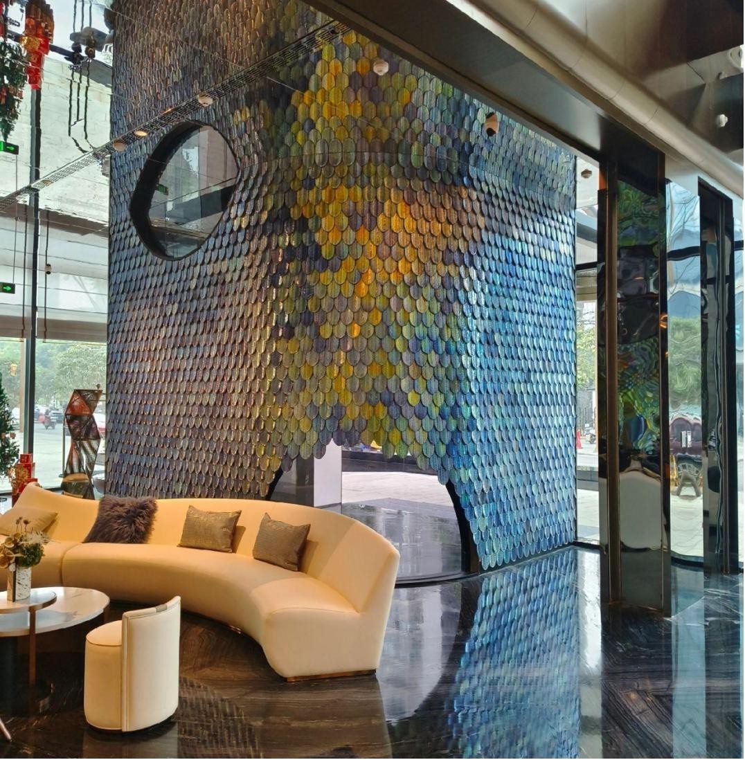 Club lounge with curved seating and a colorful crystal feature wall